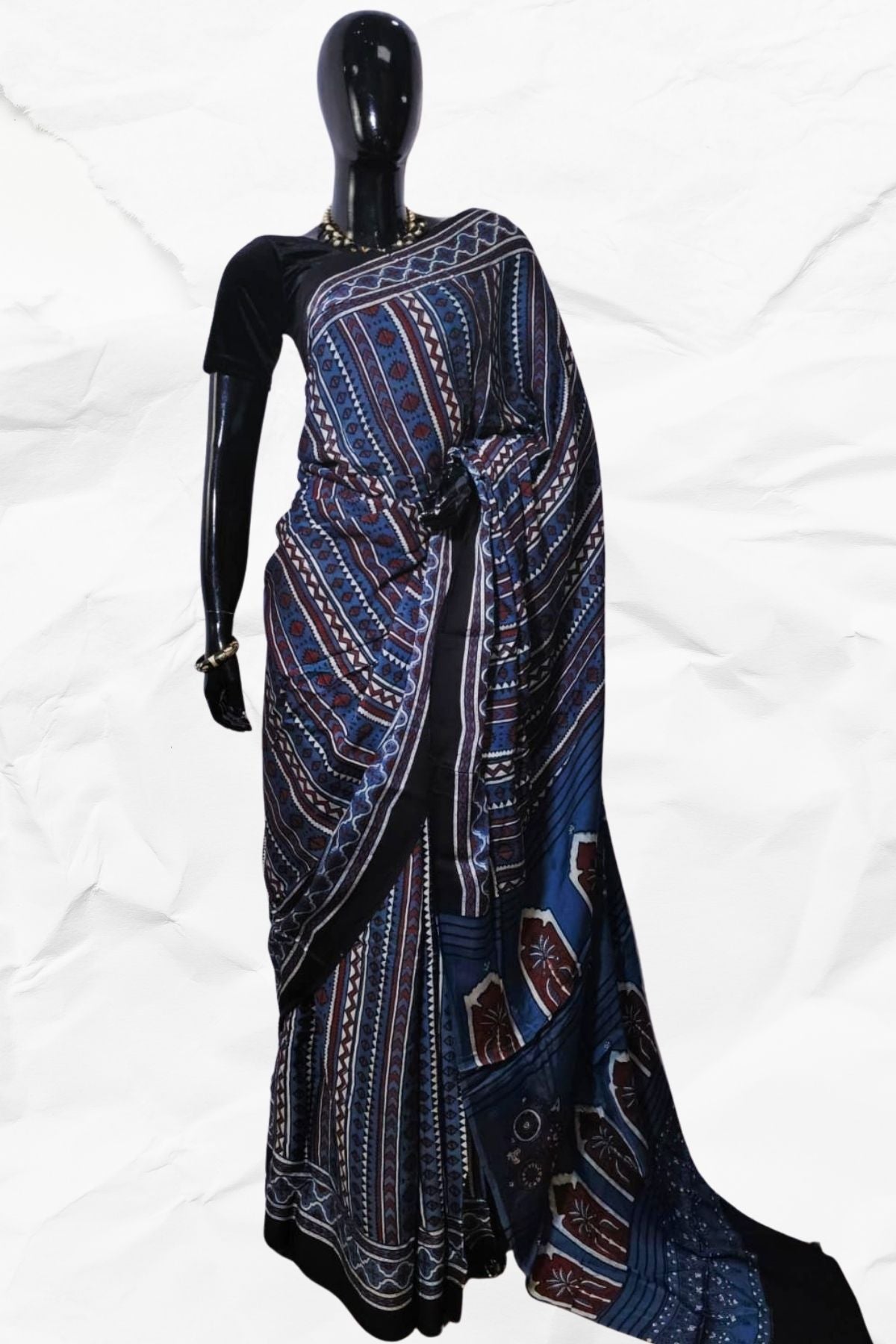 Mannequin wearing a blue and black patterned dress on a white background
