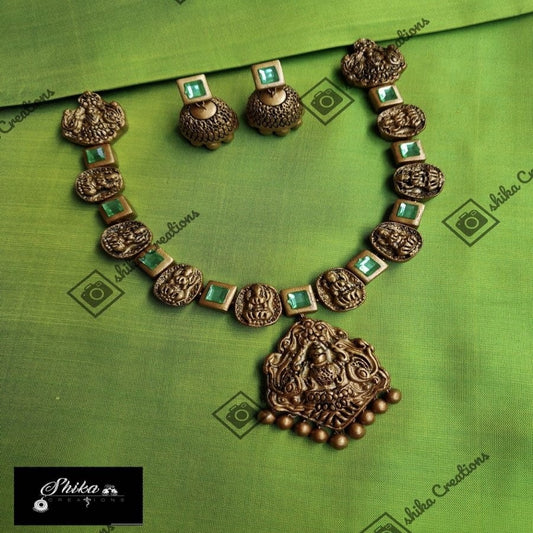 TERRACOTTA NECKWEAR AND JHUMKAS WITH ARTIFICIAL STONE EMBELLISHMENTS. COLOURS: GOLD.